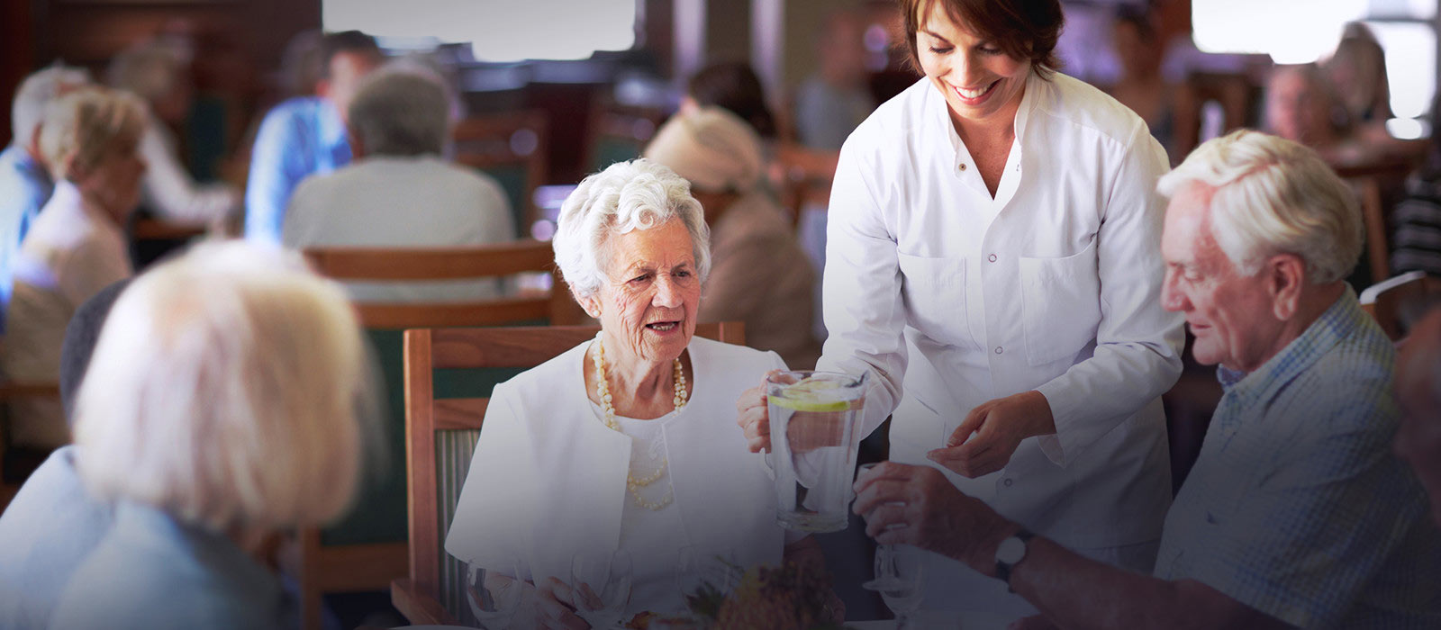 Image of elderly people sitting around a dining table